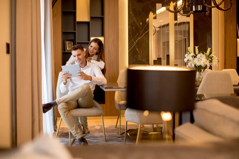 Couple reviewing a tablet together in an elegant interior
