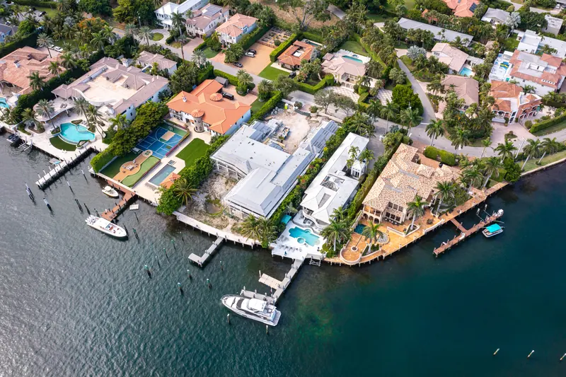 Aerial view of waterfront homes with private docks and boats